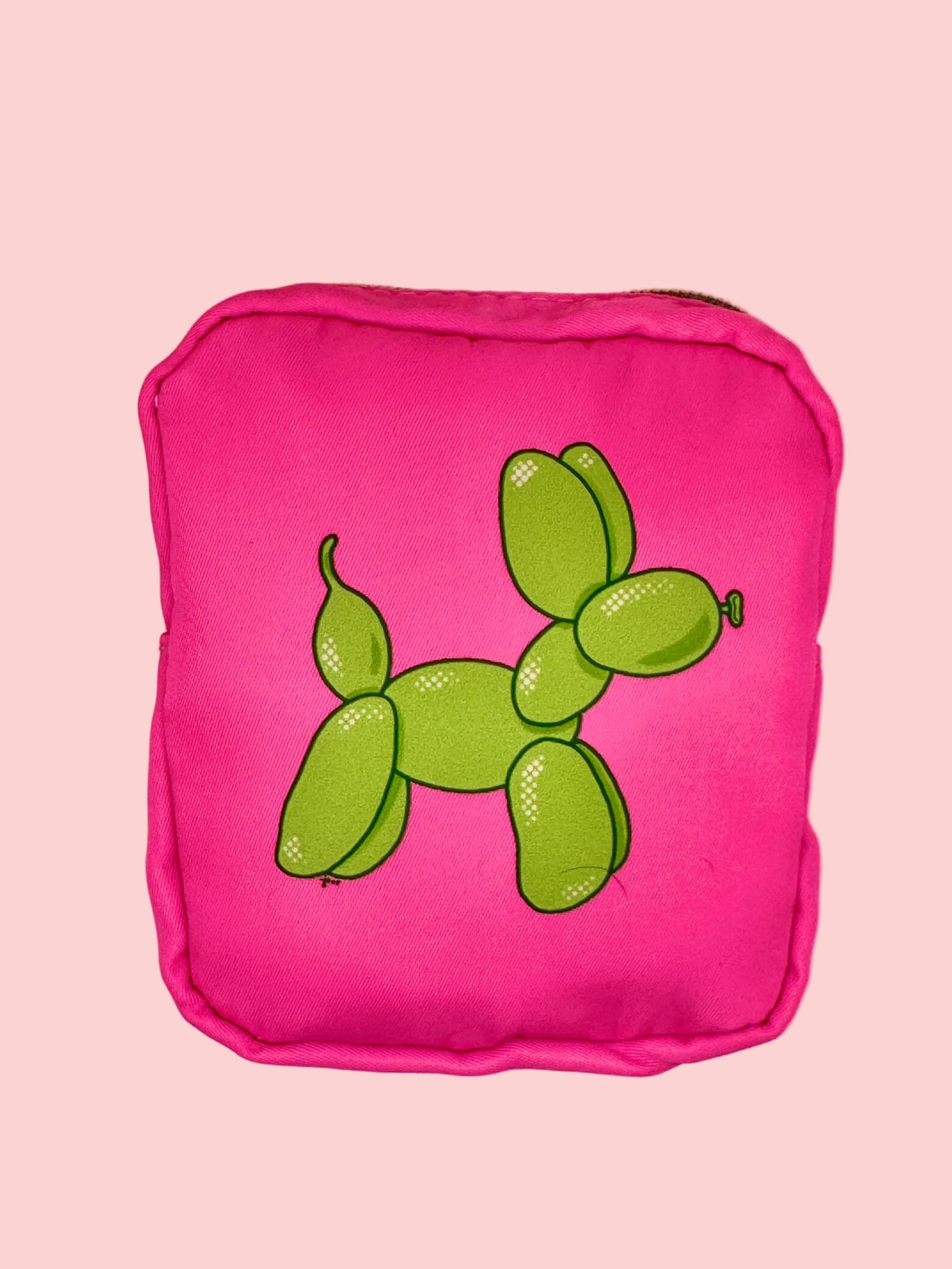 Pink pouch with green balloon dog design on a pink background