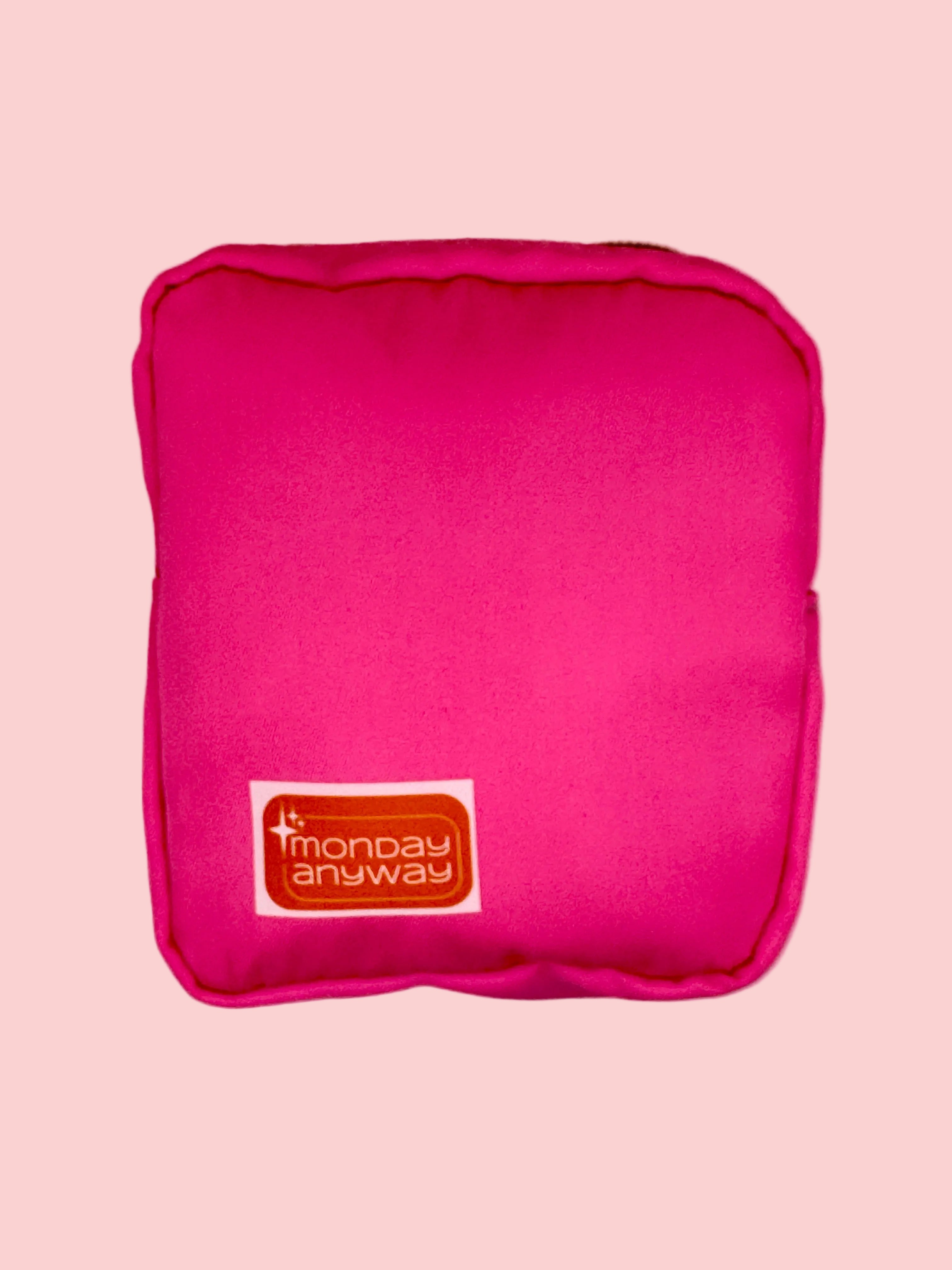 Pink mini zip pouch with a Monday Anyway brand label