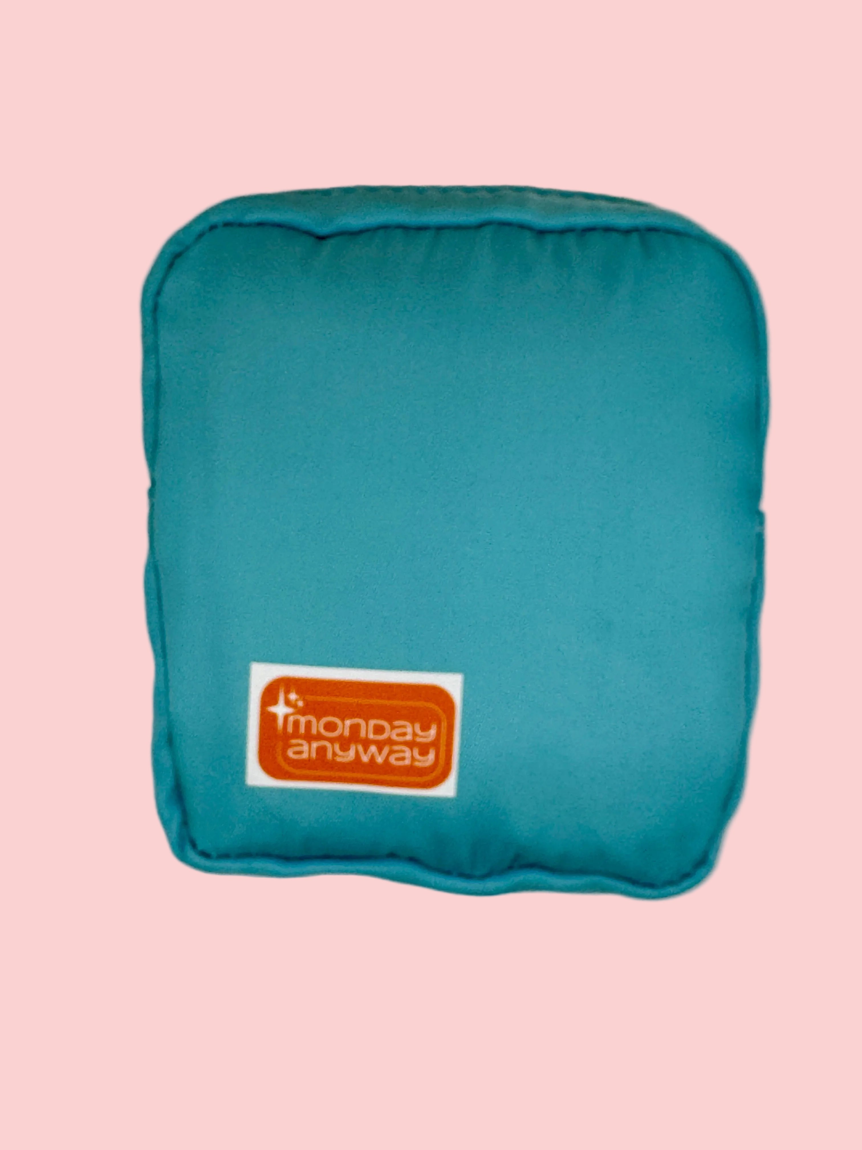 Teal pouch with 'Monday Anyway' logo