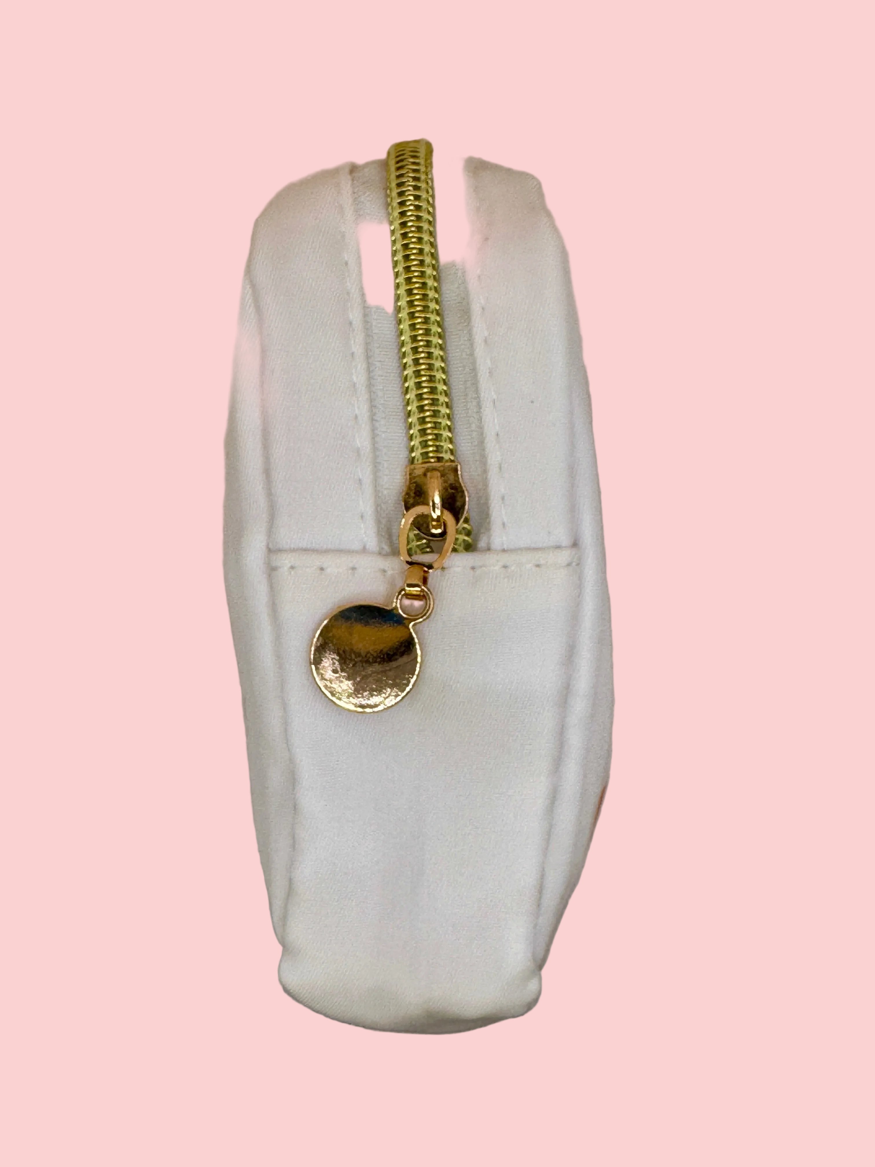 White pouch with a gold zipper 