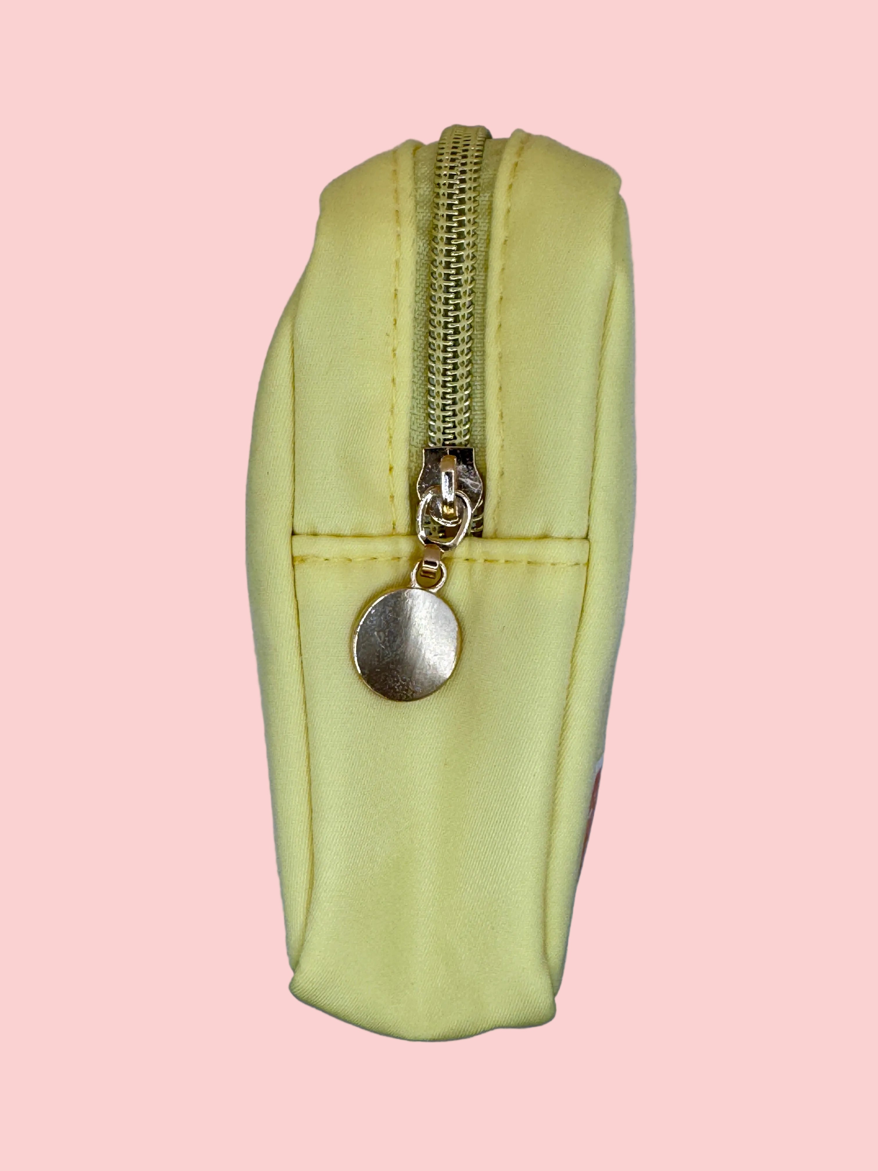 Light yellow pouch with a gold zipper