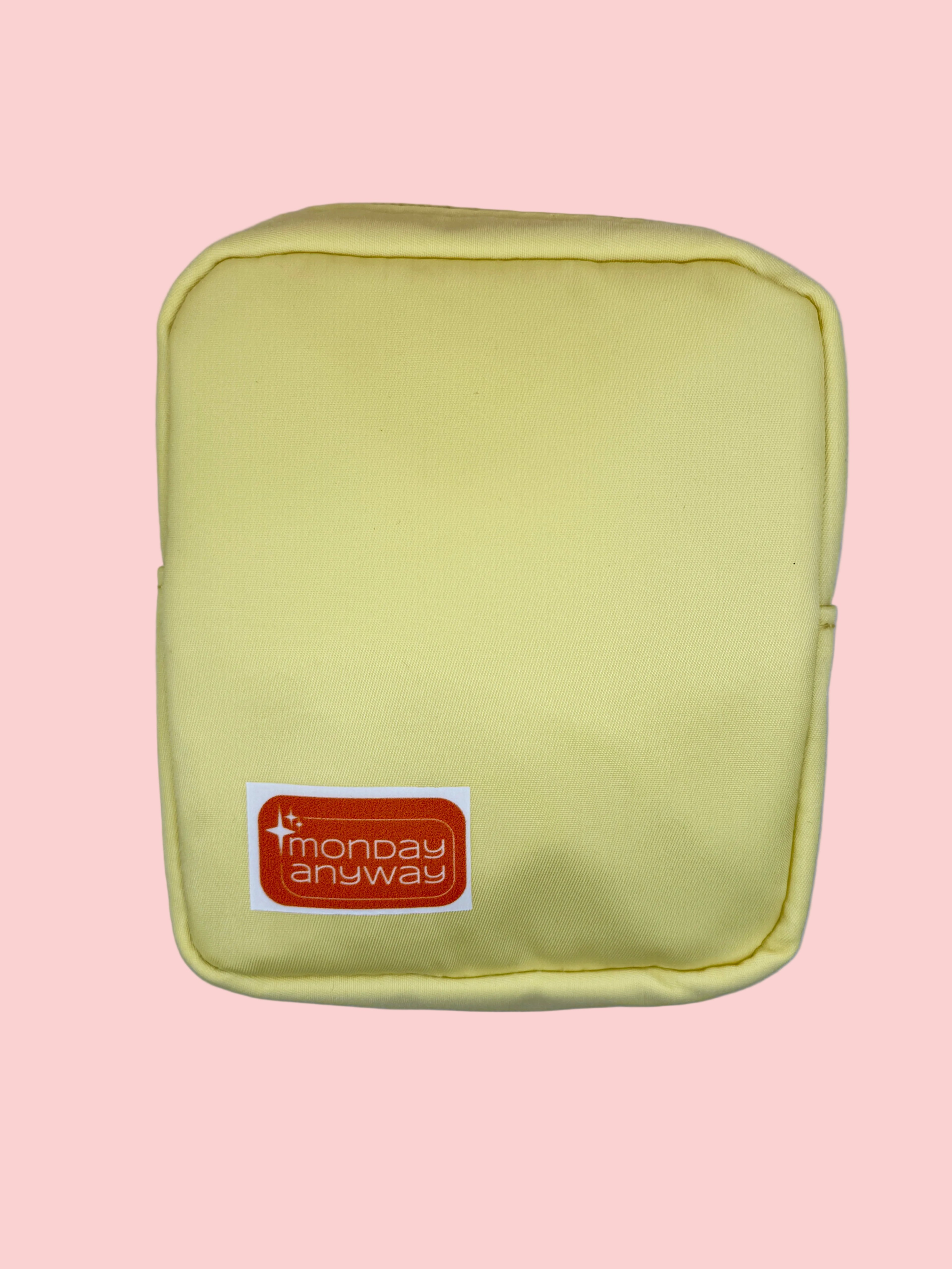 Yellow pouch with a Monday Anyway brand label