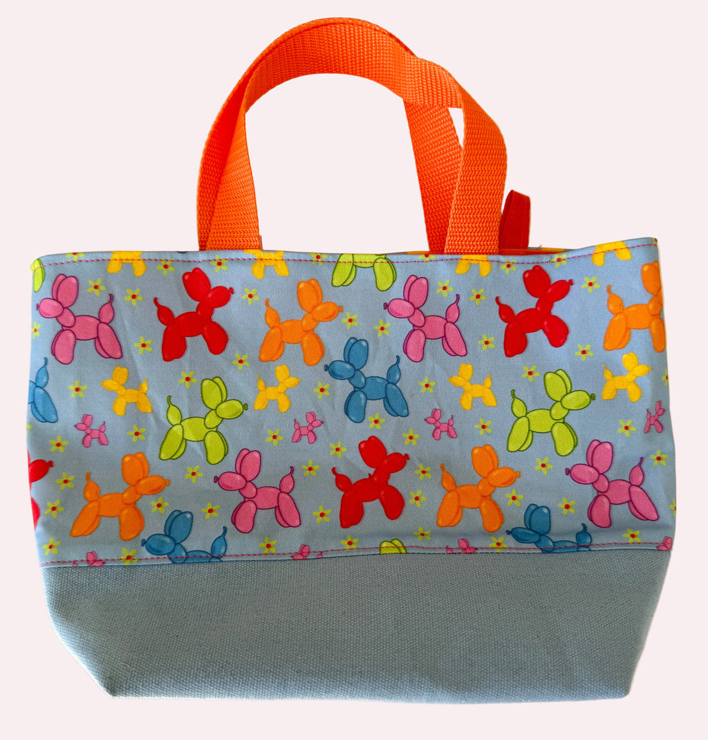 Colorful bag with balloon dog pattern on a light background