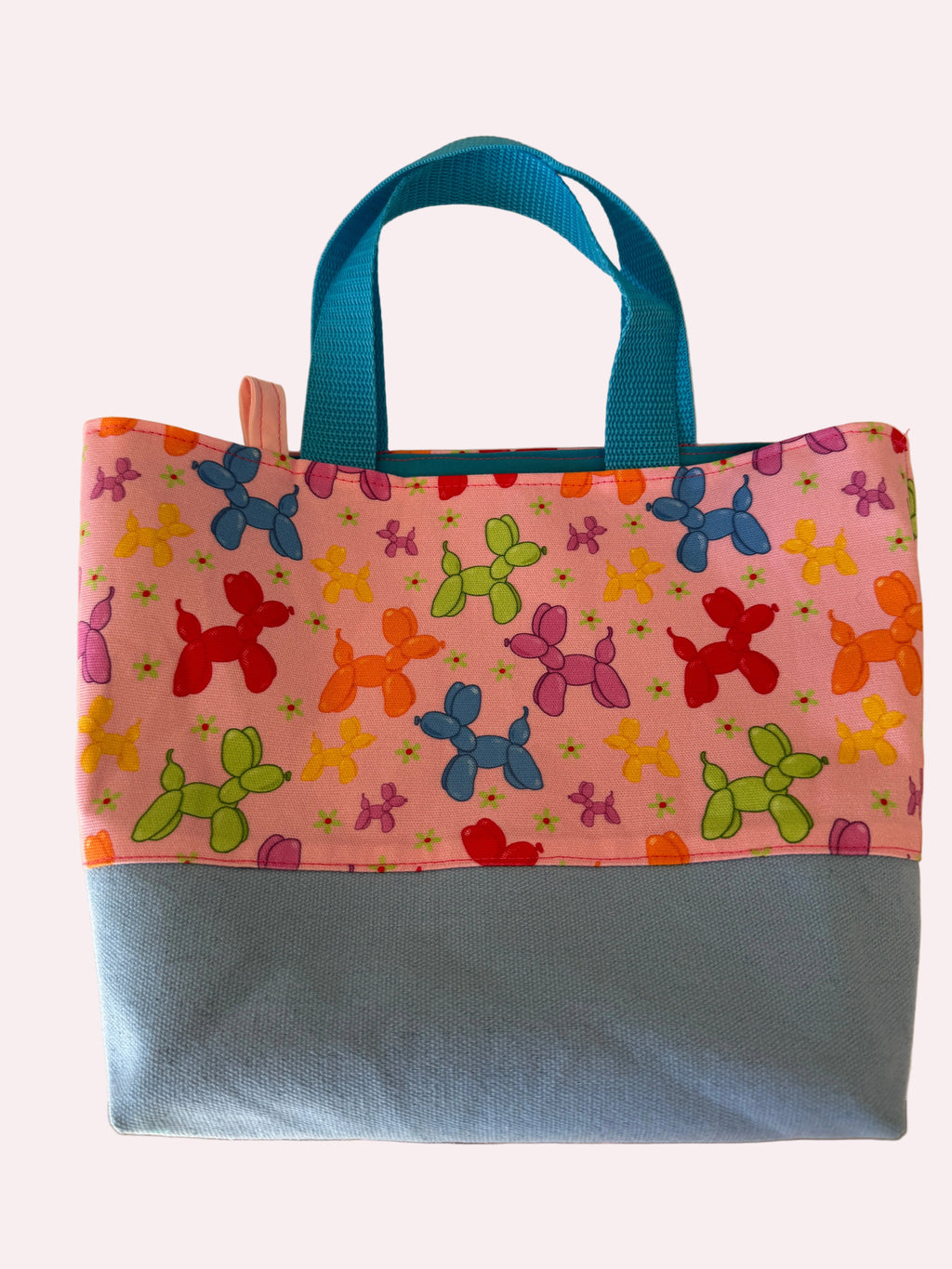 Colorful bag with balloon dog pattern on a pink background