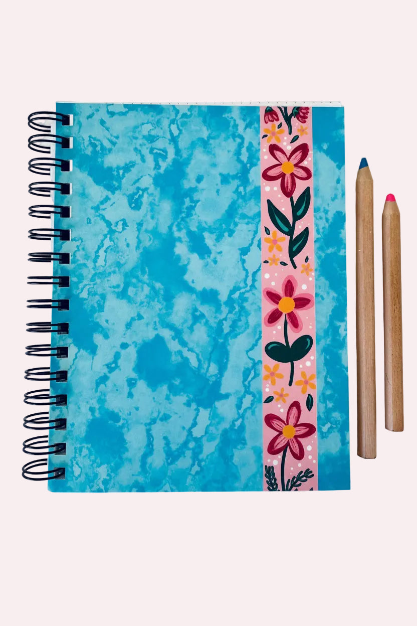Notebook with blue marbled cover and floral design on a white background