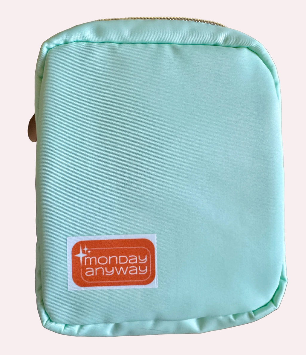 Light blue pouch with 'Monday Anyway' label 