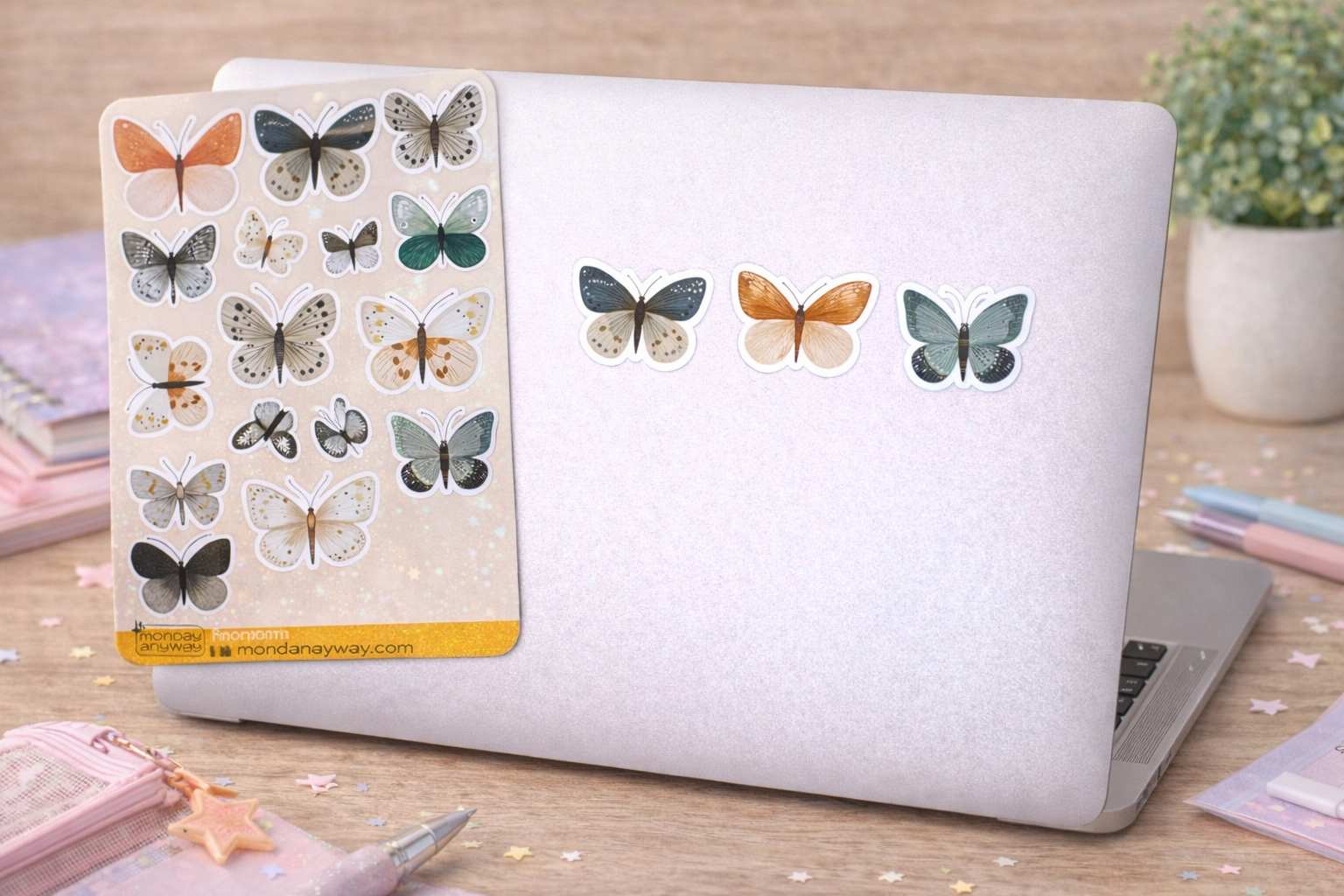 Laptop with butterfly stickers on a wooden desk